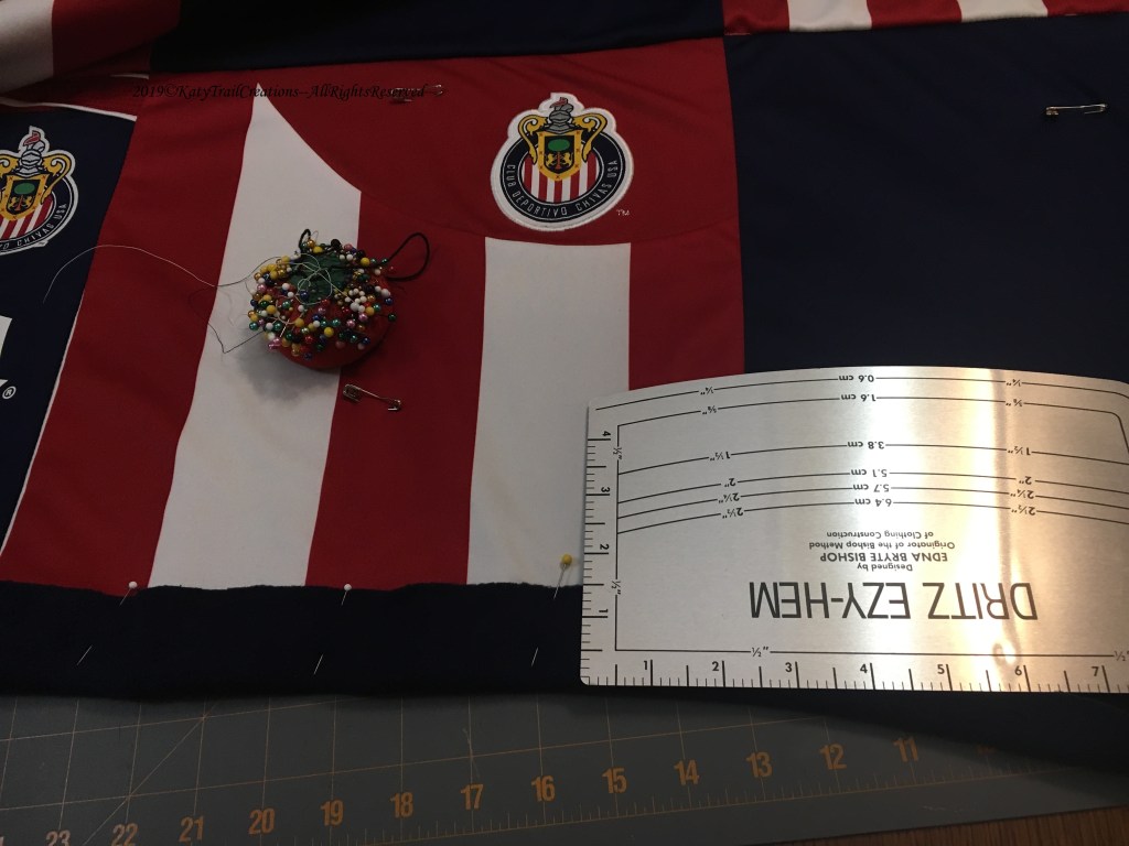 Turning up the hem to bind the edge